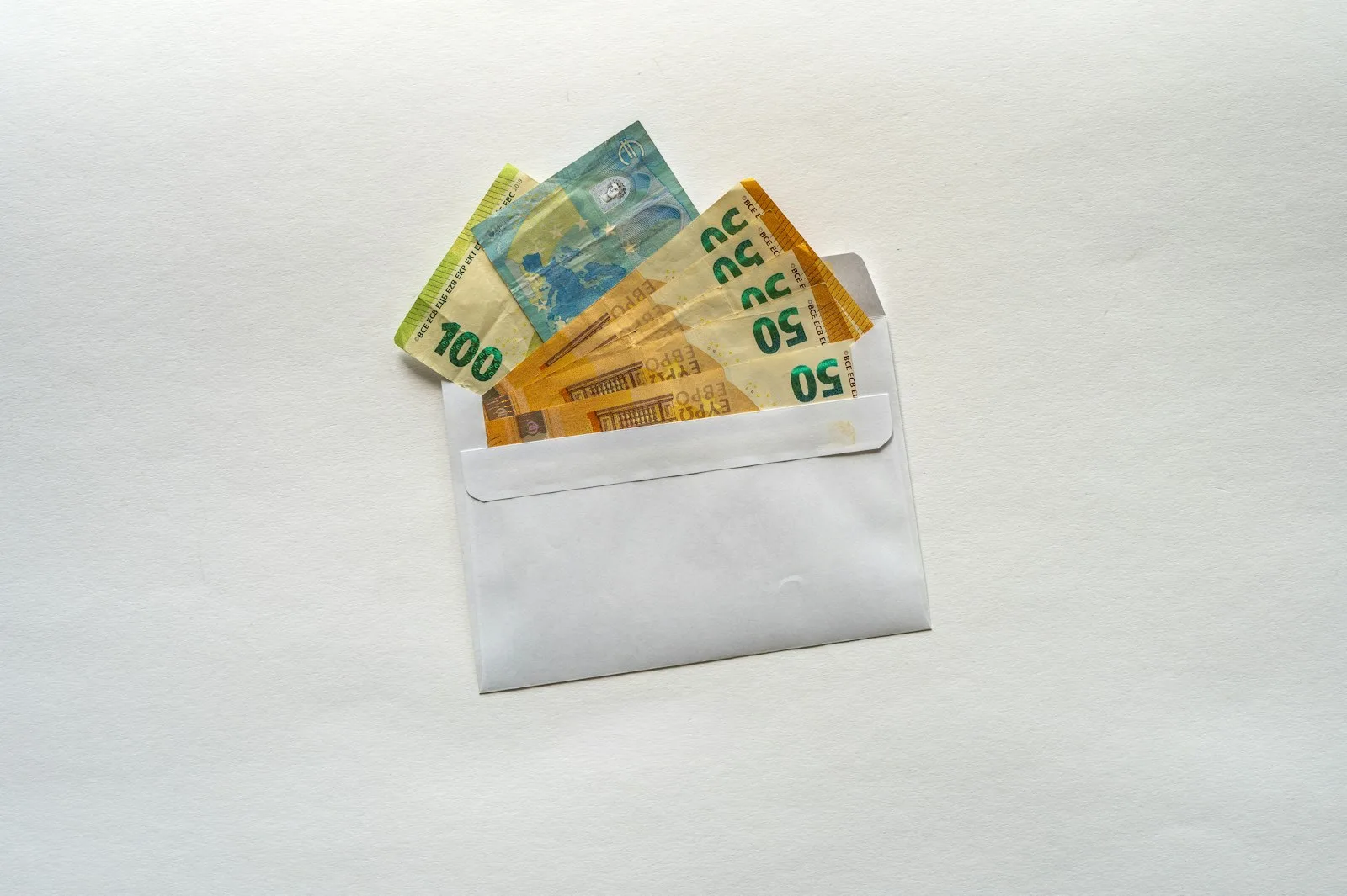 Billets en euros glissés dans une enveloppe pour faire son budget mensuel
